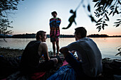 Three young men at a lake, Freilassing, Bavaria, Germany
