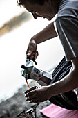 Male camper pouring himself coffee, Freilassing, Bavaria, Germany