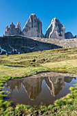 SestoSexten, Dolomites, South Tyrol, Italy. The Tre Cime di LavaredoDrei Zinnen are reflected in a lake