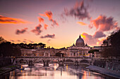 Rome, Lazio, Italy. Sunset on Tevere River, with Saint Peter Cathedral on the background.