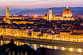 Florence, Tuscany, Italy. cityscape and Cathedral and Brunelleschi Dome, Giotto Tower. Sunset, lights on.