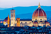 Florence, Tuscany, Italy. Cytiscape with the Cathedral and the Brunelleschi Dome, Giotto Tower at sunset, lights on.