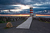Light tower of Garoskagi at sunset, built in cement, it's near the coast of the Faxafloi bay, Iceland