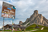 Signboard and hut at Giau Pass with Gusela mountain on the background, Dolomites, Veneto, Italy