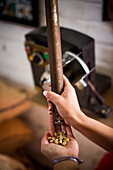 A young woman tests coffee beans while they are being roasted at a coffee facility in rural Colombia.