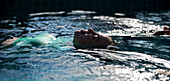 A woman floats in a swimming pool at the Koh Jum Resort on the island of Koh Jum, Thailand, on May 3, 2015.