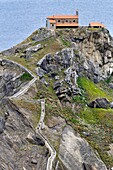 Gaztelugatxe, islet on the coast of Biscay. Connected to the mainland by a man-made bridge. On top of the island stands a hermitage named Gaztelugatxeko Doniene in Basque, San Juan de Gaztelugatxe in Spanish, dedicated to John the Baptist, that dates from