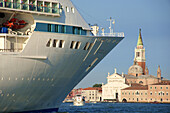 Tourist Cruise liner and vaporetto sailing on Bacino di San Marco, Venice, Italy.