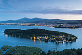 Greece, Epirus Region, Ioannina, elevated city view, Lake Pamvotis and Nisi Island, dusk.