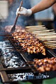 Australia, Victoria, VIC, Melbourne, Queen Victoria Market, ethnic food market, grilled food.