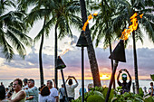 Hawaii, Hawaiian, Honolulu, Waikiki Beach, Kuhio Beach Park, Pacific Ocean, sunset, Waikiki Bay, palm trees, tiki lanterns, lit, fire,.