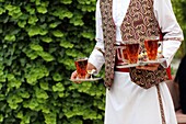 Waiter carrying hot tea, Abbasi Hotel, Esfahan, Iran, Asian.