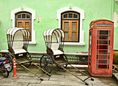 trishaws and phone booth at the Pinang Peranakan Mansion in Georgetown, Penang, Malaysia.