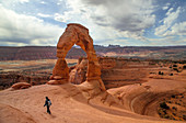 Delicate Arch stands prominent during threatening skies at Arches National Park, Utah.
