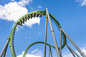 Park guest riding the Incredible Hulk Roller Coaster in Marvel Super Hero Island at Universal Studios Islands of Adventure park.