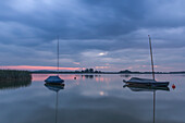 Boats floating at the shore of the Rangsdorf lake at sunset - Long Exposure - Germany, Brandenburg, Rangsdorf