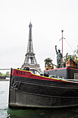 View over the river Seine towards the Eiffel Tower, house boats, Paris, Ile-de-France, France