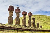 Moai with scoria red topknots at the restored ceremonial site of Ahu Nau Nau at Anakena on Easter Island, Isla de Pascua, Rapa Nui, Chile.