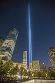 The Tribute in Light is seen behind the 9/11 Memorial waterfalls and reflecting pool in New York on September 11, 2014 for the13th anniversary of the September 11, 2001 terrorist attacks. The 88 high intensity lights that comprise the tribute create two v