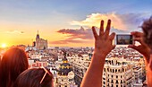 People watching the sunset from The Circulo de Bellas artes cultural center rooftop terrace. Madrid. Spain.