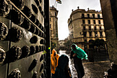 Tourists during rainfall at the side entrance of the cathedral in the historical centre, Seville, Andalusia, province Seville, Spain
