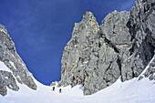 Two persons back-country skiing ascending to Mandlkogelscharte, Mandlkogelscharte, Gosau range, Dachstein, Salzburg, Austria