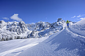 Woman back-country skiing ascending to Kampl, Gosau range with Bischofsmuetze in background, Kampl, Gosau range, Dachstein, Salzburg, Austria
