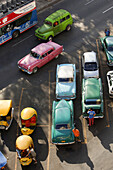 Old american cars and Coco Taxis parked at the street, Havana, Cuba, West Indies, Central America.