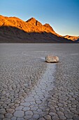 Tracks left by mysterious moving rocks on the dried flat mud at the Racetrack Playa, Death Valley National Park, California.