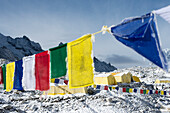 Prayer flags and the Everest base camp at the end of the Khumbu glacier that lies at 5350m, Himalayas, Nepal, Asia