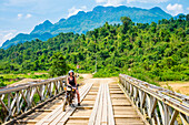 Young woman on motorbike, Vang Vieng, Vientiane Province, Laos