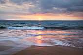 'Soft ocean waves at sunset from Kamaole Beach; Maui, Hawaii, United States of Amerida'