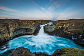 'Waterfall flowing from a stream and rugged cliffs; Aldeyjarfoss, Iceland'