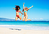 Two Attractive Girls in Bikinis Jumping on the Beach. Best Friends Having Fun, Summer Lifestyle.