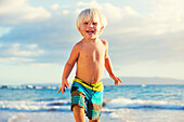 Happy young boy playing at the beach