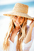 Fashion lifestyle, Portrait of beautiful happy blond girl on the beach