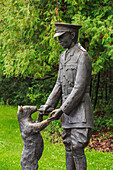 'Bronze statue of Winnie the Pooh with Lieutenant Harry Colebourn in Assiniboine Park; Winnipeg, Manitoba, Canada'