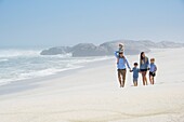 Family walking on the beach