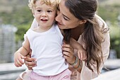 Close-up of happy mother playing with son