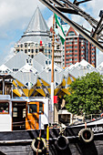 View over the historical boat Tijgerhaai in the Oudehaven towards the yellow cube houses and the ''pencil'' high rise building in the background, Rotterdam, Netherlands