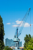 View of the concert hall Elbphilharmonie with a shipyard crane in the foreground, Hamburg, Hafencity, Germany