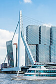 Ein Ausflugsboot auf der Maas passiert die Erasmusbrücke mit Blick auf das Hochhaus ''De Rotterdam'' am Südufer, Rotterdam, Provinz Südholland, Niederlande