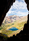 Europe, Italy, Lombardy. Nero lake at Gaviapass from a war rift in the rocks of mountains