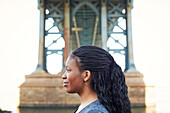 Profile of smiling Black woman at bridge