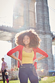 Smiling Black woman posing with hands on hips