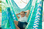 Caucasian girl laying in hammock