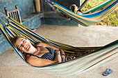 Caucasian woman laying in hammock
