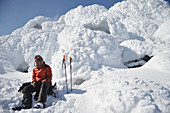 Male skier on the steaming summit of  Mt Augustine, a 4,025-foot high active volcano on Augustine Island in Cook Inlet, Alaska. The lava dome volcano is part of the Ring of Fire and last erupted in 2006.