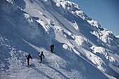 Skiers descend from the summit of  Mt Augustine, a 4,025-foot high active volcano on Augustine Island in Cook Inlet, Alaska. The run back to the coast line includes boulders covered in rime ice and soaring volcanic towers. The lava dome volcano is part of