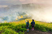 Two women hiker on the top of volcano Batur